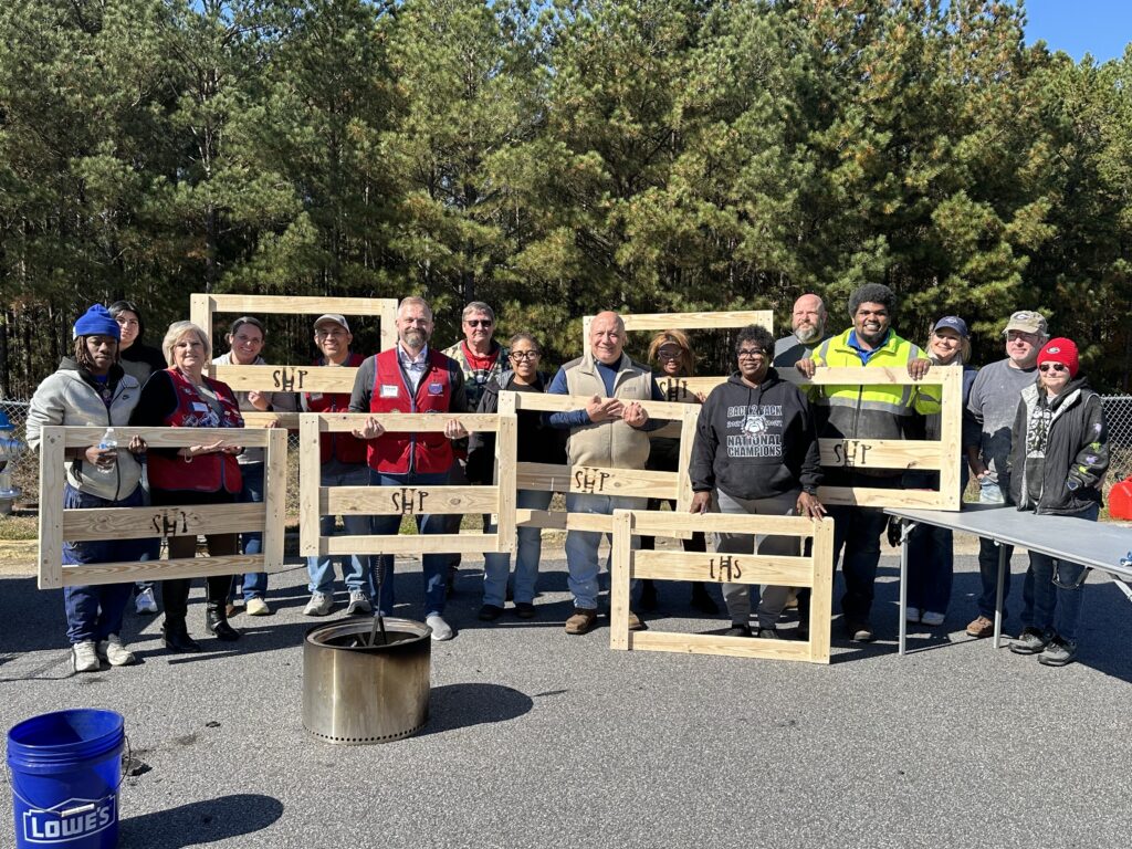 Lowe's Hometown Heroes Bed Build SHP Jackson County, Georgia Sleep in Heavenly Peace Jackson County Georgia chapter volunteers and Lowe's store associates holding handcrafted SHP bed frames for children in need